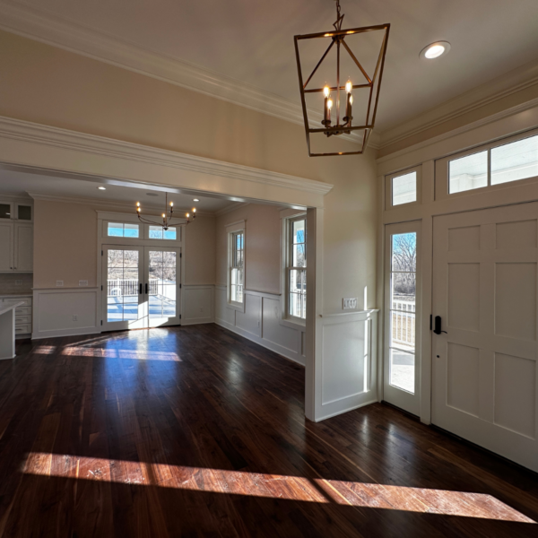 Spacious open-concept living and dining area with hardwood flooring and natural lighting.
