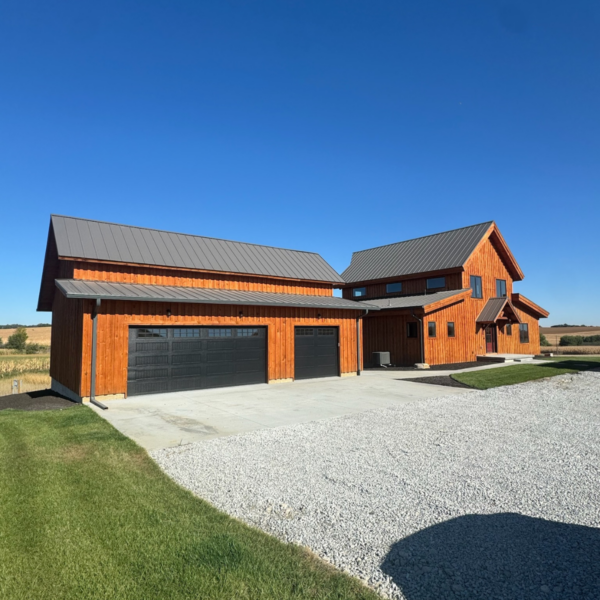 Spacious three-car garage attached to a timber-frame home.