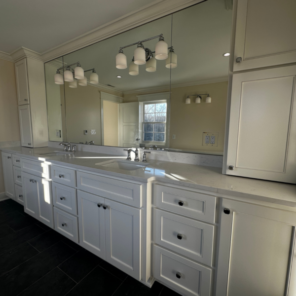 Elegant white bathroom vanity with double sinks and oversized mirror
