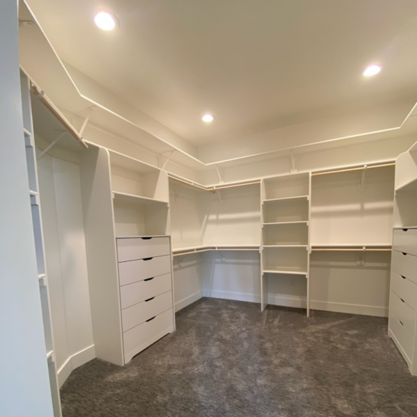 Custom walk-in closet with built-in shelving, drawers, and ample storage space.
