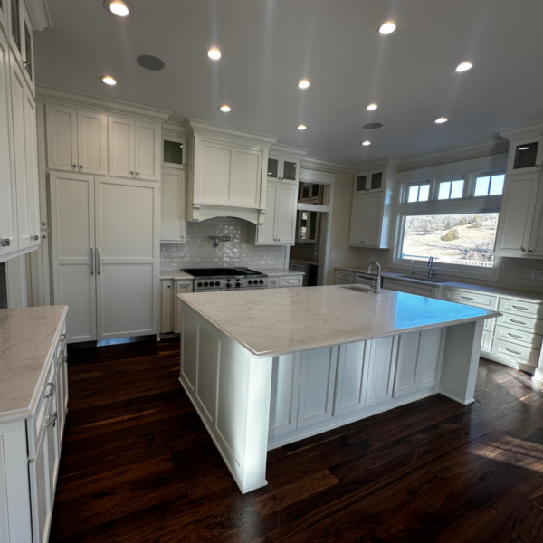 Custom white kitchen with a large center island and high-end appliances