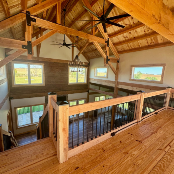 Overhead view of a living room with vaulted ceilings and timber beams.